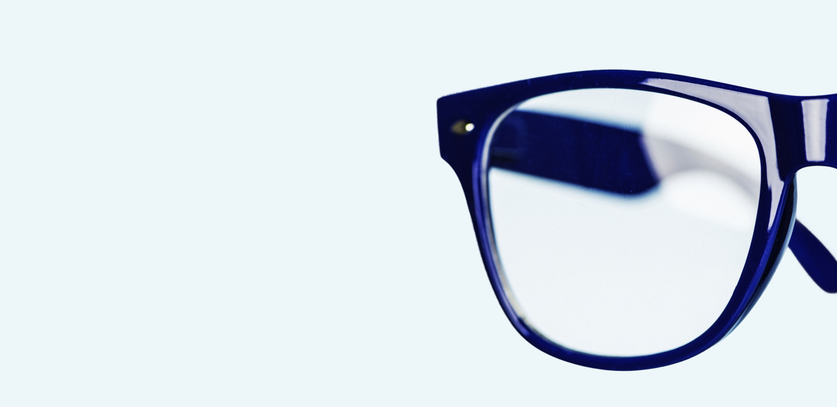 Close-up of glasses lens showing clean, well-maintained eyewear