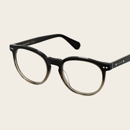 Mens Round black eyeglasses with subtle gradient on frames against a light beige background,