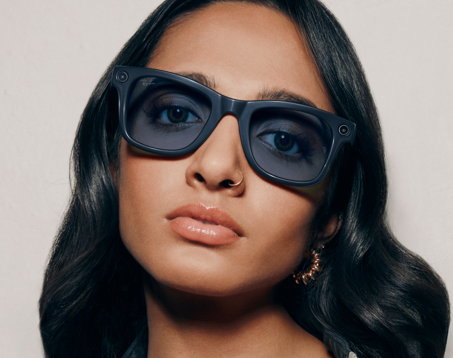 Young woman wearing large black AI Glasses with Transitions&reg; Lenses, confident look