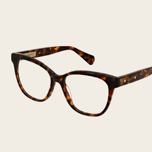 Womens Tortoiseshell square glasses with gold accents on a cream background, stylish and timeless.
