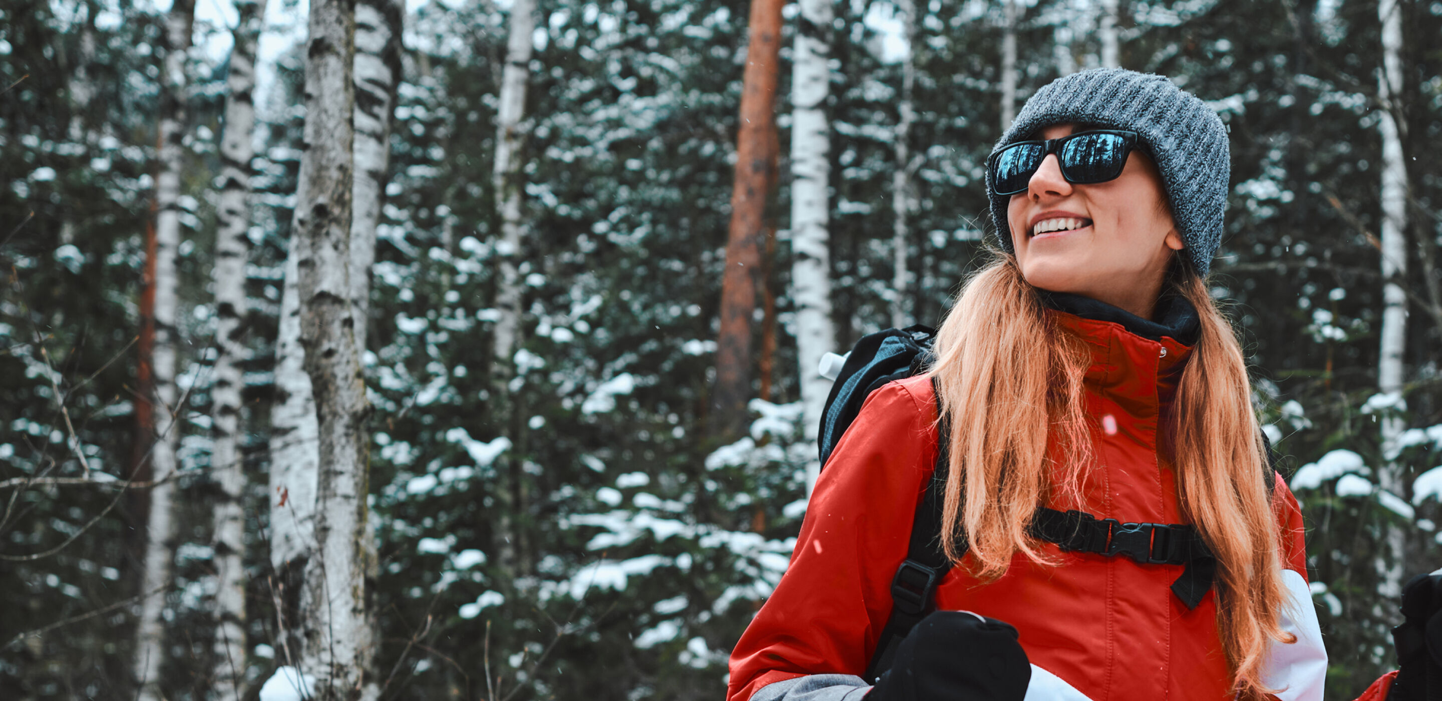 Woman wearing boots opticians sunglasses, hiking in snowy forest, ideal for winter sports vision protection