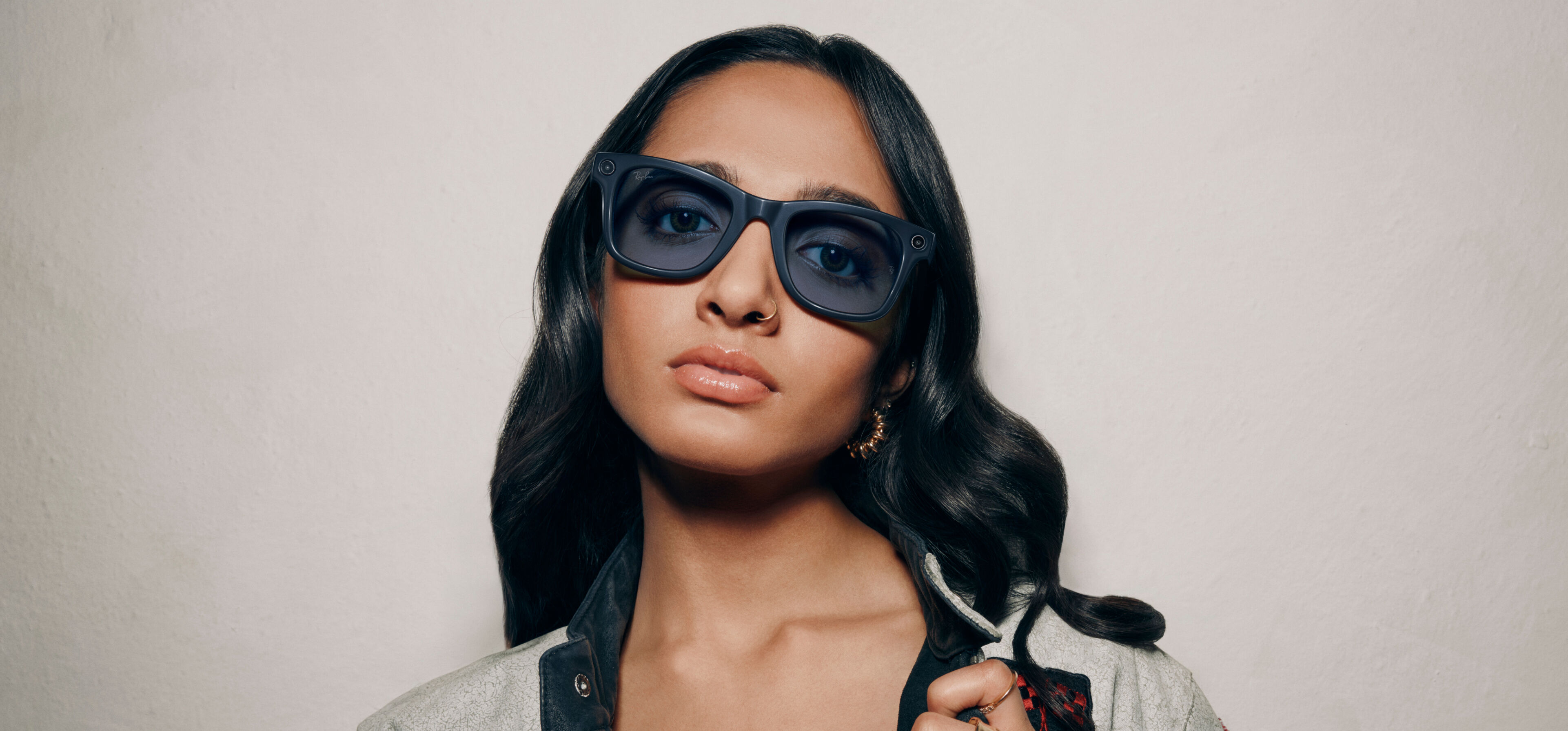 Young woman wearing large black AI Glasses with Transitions&reg; Lenses, confident look