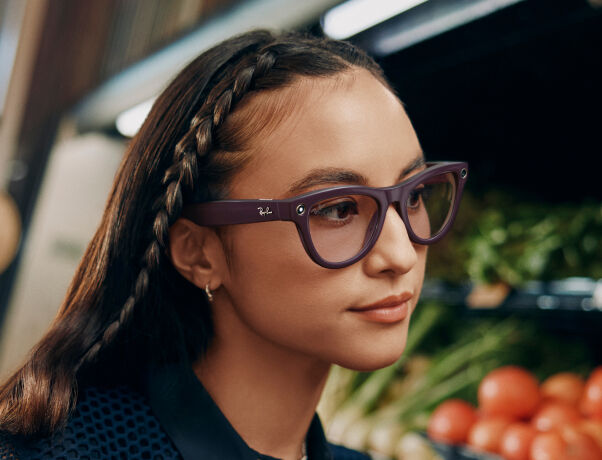 Woman wearing purple smart glasses, styled confidently in soft lighting for smart eyewear
