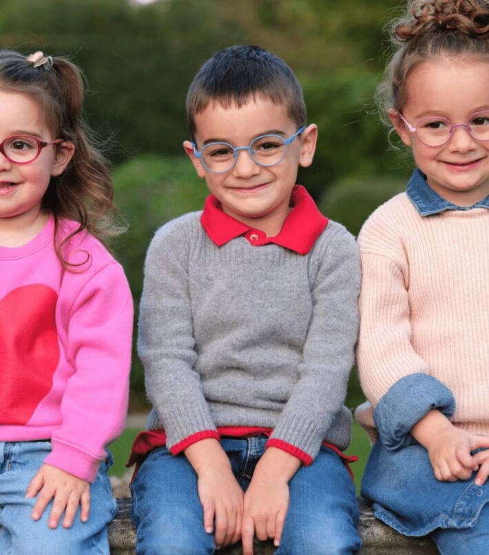 Three children wearing colourful glasses outdoors, highlighting comfortable eyewear for kids.