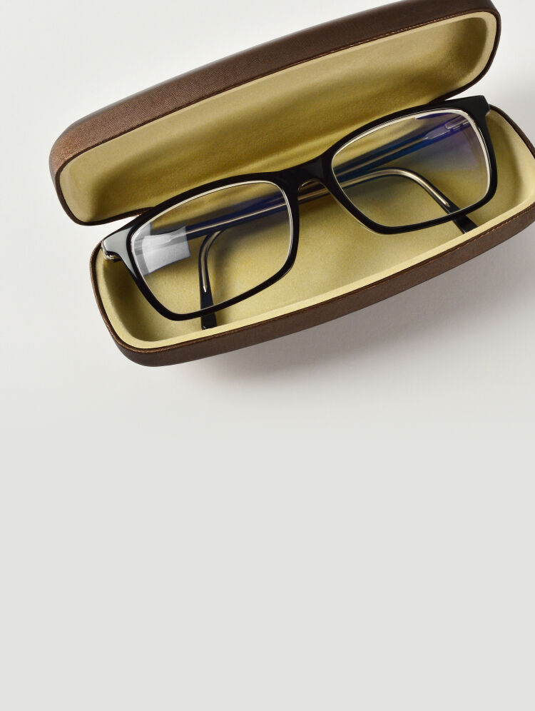 Eyeglasses stored in a protective case to prevent damage.