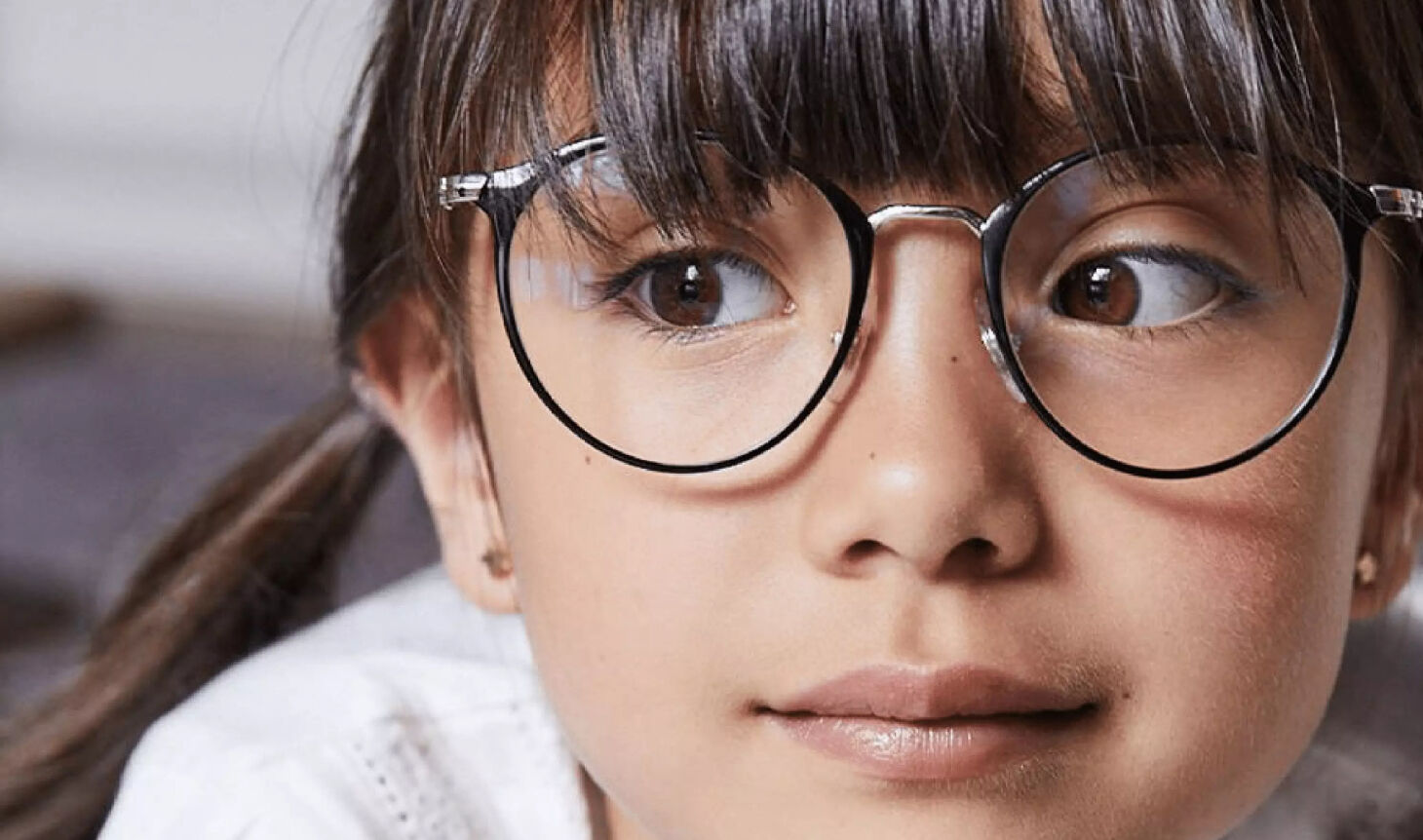 Young girl wearing glasses, reflecting early vision care and myopia awareness in children.